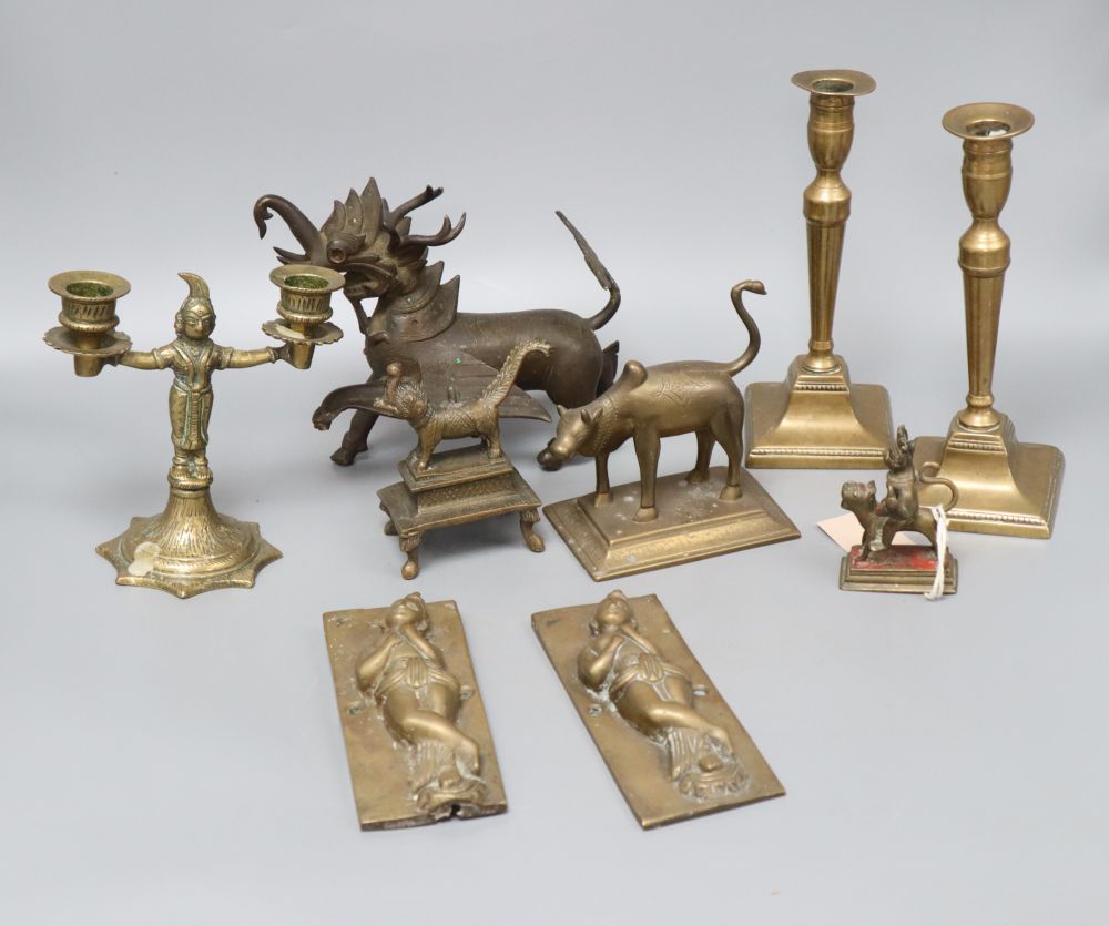 A quantity of mixed metalware including a pair of Indian deities, a pair of candlesticks and a dragon, tallest 19cm